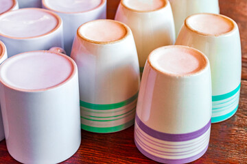 White coffee cups on wooden table tropical Holbox island Mexico.