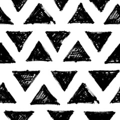 Obraz premium Seamless pattern with black triangular silhouettes. Abstract geometric hipster fashion design print. Handdrawn shapes of triangles with rough edges in grunge style. Vector black and white ornament.