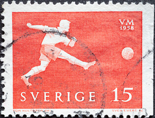 Sweden - circa 1958: a postage stamp from Sweden showing a successful player with the ball while shooting. FIFA World Cup 1958