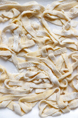 Homemade tagliatelle pasta just made and still raw - 480003667