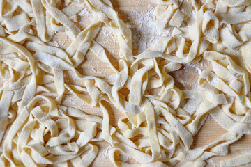 Homemade tagliatelle pasta just made and still raw - 480003683