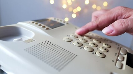closeup female hand presses the buttons of the stationary white office phone, dials the subscriber's number for communication, the concept of hotline help, call center, selective focus - Powered by Adobe