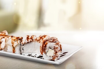 Warm sushi set on board with wassabi and soy sauce.