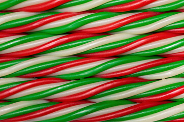Christmas liquorice candy in red white and green striped and twisted close up 