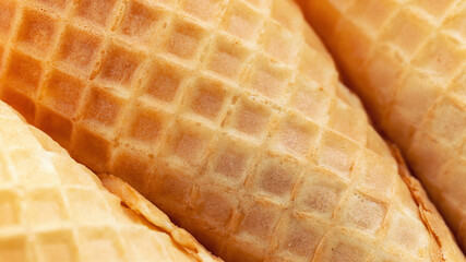 Crispy waffles macro photography. Ice cream cone close-up. High resolution waffle cone texture with copy space.