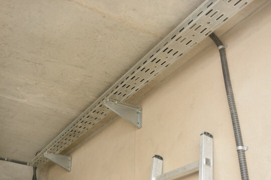 Cable route, perforated cable tray indoors. Installation of electrical equipment