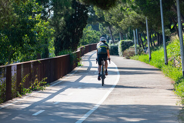 A cyclist circulating with his bicycle along the bike lane in the city of Barcelona