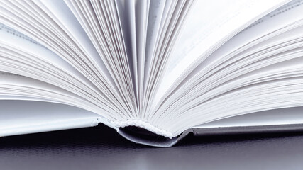 White pages of an open book macro photography. Sustainable education concept. The concepts of visiting the library, reading books, encyclopedias and fiction.