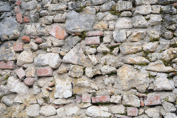 beautiful vintage texture of the wall of a medieval castle built in the middle of the 14th century, multi-colored volumetric stones for the designer, wallpaper, background