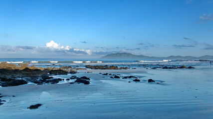 Rugged beach with mountains in the background in Tamarindo, Costa Rica