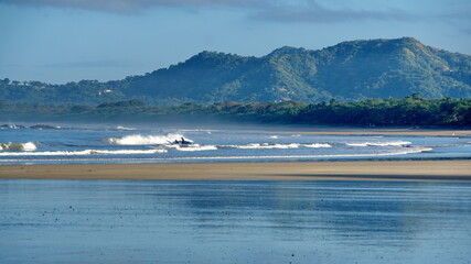 Landscape with a beach in front of the mountains in Tamarindo, Costa Rica
