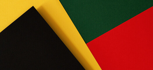Abstract geometric black, red, yellow, green color paper background. Black History Month color...