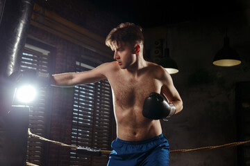 Fototapeta na wymiar A male boxer is training in the gym.