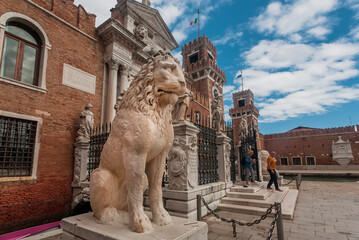 Lion sculpture at entrance of Venice Arsenal, the former shipyards complex under clouds