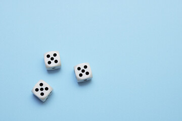 three dice with the same dropped out numbers lie on a blue background
