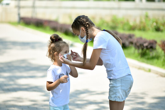 A teenage girl takes care of her younger sister.