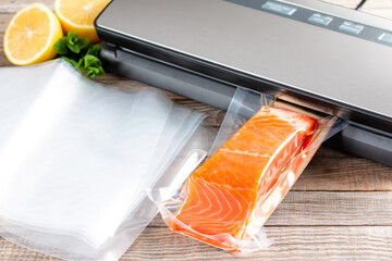 Salmon fillets in a vacuum package. Vacuumation food. Sous-vide, new technology cuisine. - obrazy, fototapety, plakaty