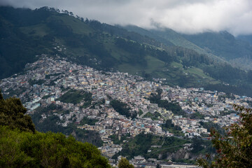 Fototapeta na wymiar Cityscapes of the capital of Ecuador - Quito from the mountain on a cloudy day 