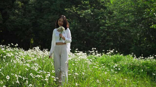 young woman holding flower walk in the park