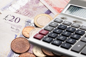 Money banknotes on a wooden table with a calculator Economics and financial planning