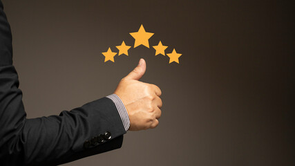 The businessman gave a thumbs up for his satisfaction rating. Service rating up to 5 stars,...
