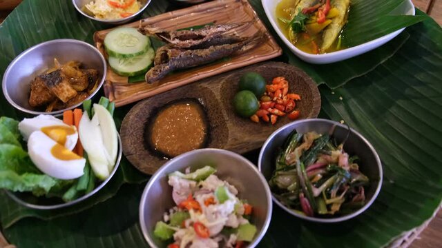 Traditional Kadazan food, served with ambuyat/ sago & soup(cacahan), with side dishes of tuhau, bambangan, salted fish, pickles, homemade sambah belacan ,with main of pinasakan bosungan.