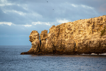 uninhabited islands of the Galapagos archipelago against the backdrop of the sea and blue sky 