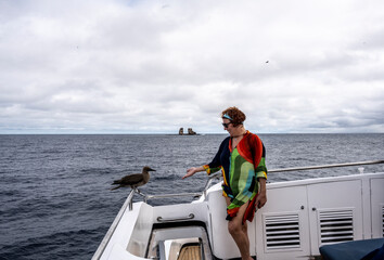 woman tourist on the background of a landscape with views of the islands of the Galapagos...
