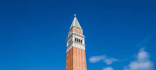 Fototapeta na wymiar Campanile (Campanile di San Marco)on the blue sky background. Venice, Italy,