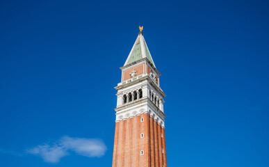 Fototapeta na wymiar Campanile (Campanile di San Marco)on the blue sky background. Venice, Italy,
