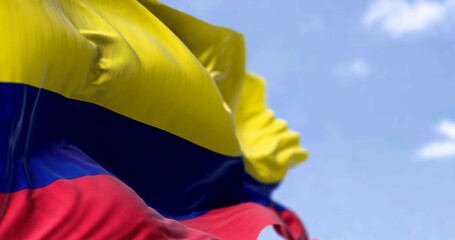 Detailed close up of the national flag of Colombia waving in the wind on a clear day