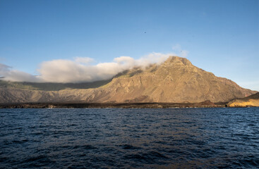 uninhabited islands of the Galapagos archipelago against the backdrop of the sea and blue sky 