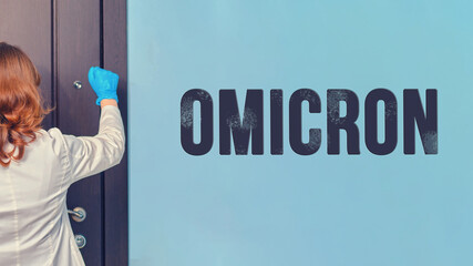 Woman doctor knocks on the door of the apartment with an inscription with a new version of Omicron...