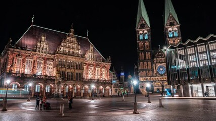 4k Timelapse of night traffic in front of historic town hall Bremen Germany with tram traffic and people moving.