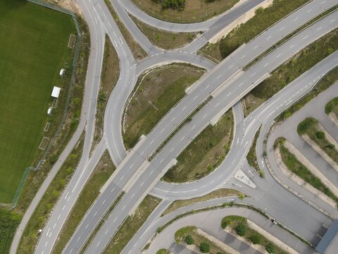 Aerial of roundabout no traffic , motorway in Regensburg Germany Europe, intersection with exit, slip road to parking lot, few cars, drone