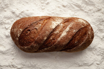 Recipe for brown rye bread. A loaf of flour.