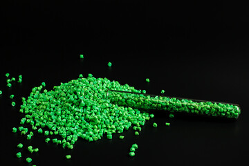 Green granules of polypropylene, polyamide. Background. Plastic and polymer industry. Microplastic...