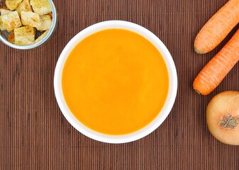 Soup with carrots, onion and bread croutons.