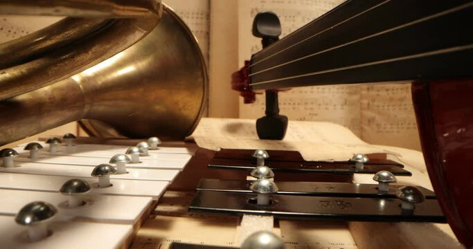 Violin, trumpet, vibraphone , cymbals lying on the notes. Musical instruments on a background with sheet music . Music, musical instruments, orchestra, sheet music,