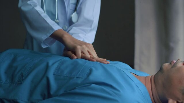 Doctor doing cardio pulmonary resuscitation on an unconscious patient