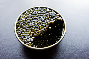 Black caviar. A can of Sturgeon Eggs already started in a restaurant.