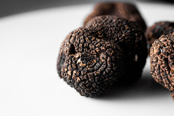 Detail of a freshly picked organic black truffle, ready to serve in a restaurant. Tuber nigrum