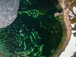bird's-eye view of Jezero Jasna. Icy man-made lake in Slovenia. Snowy lakeside
