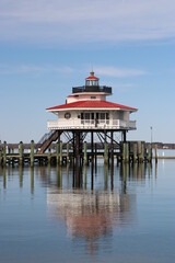Lighthouse Cambridge Maryland sits over Choptank river in Chesapeake bay with reflection. ...