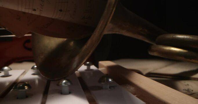 Violin, trumpet, vibraphone , cymbals lying on the notes. Musical instruments on a background with sheet music . Music, musical instruments, orchestra, sheet music,