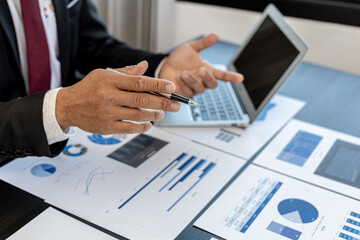 Business men are looking at the company's financial documents to analyze problems and find solutions before bringing the information to a meeting with a partner. Financial concept.