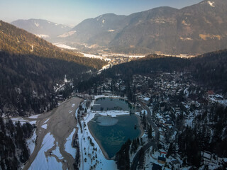 Aerial view of famous lake Jezero Jasna, glowing julian alps in the background, Slovenia