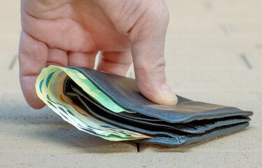 Hand grabs wallet from street floor.
