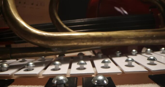 Violin, trumpet, vibraphone , cymbals lying on the notes. Musical instruments on a background with sheet music . Music, musical instruments, orchestra, sheet music,