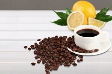 Lemon black coffee in cup, coffee beans, lemon slices